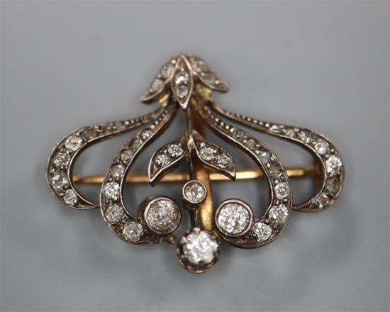 A Victorian yellow metal and diamond set scrolling pendant brooch, 29mm, gross 5 grams.